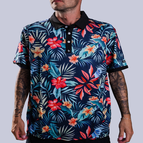Men’s navy polo with bold coral and teal tropical floral print – vibrant, breathable, performance-ready.