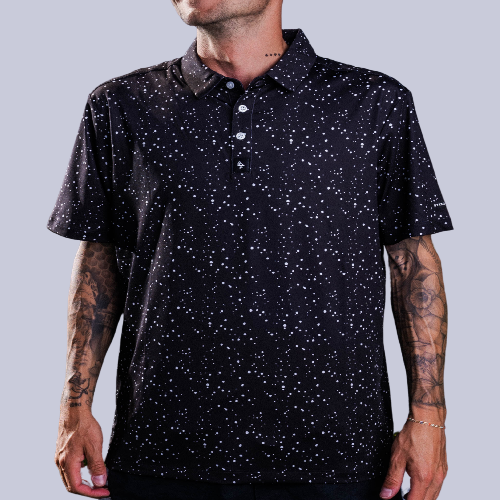 Men’s black polo with subtle gray-white speckle “cosmic sprinkle” print – sleek, breathable, stretch-performance ready.