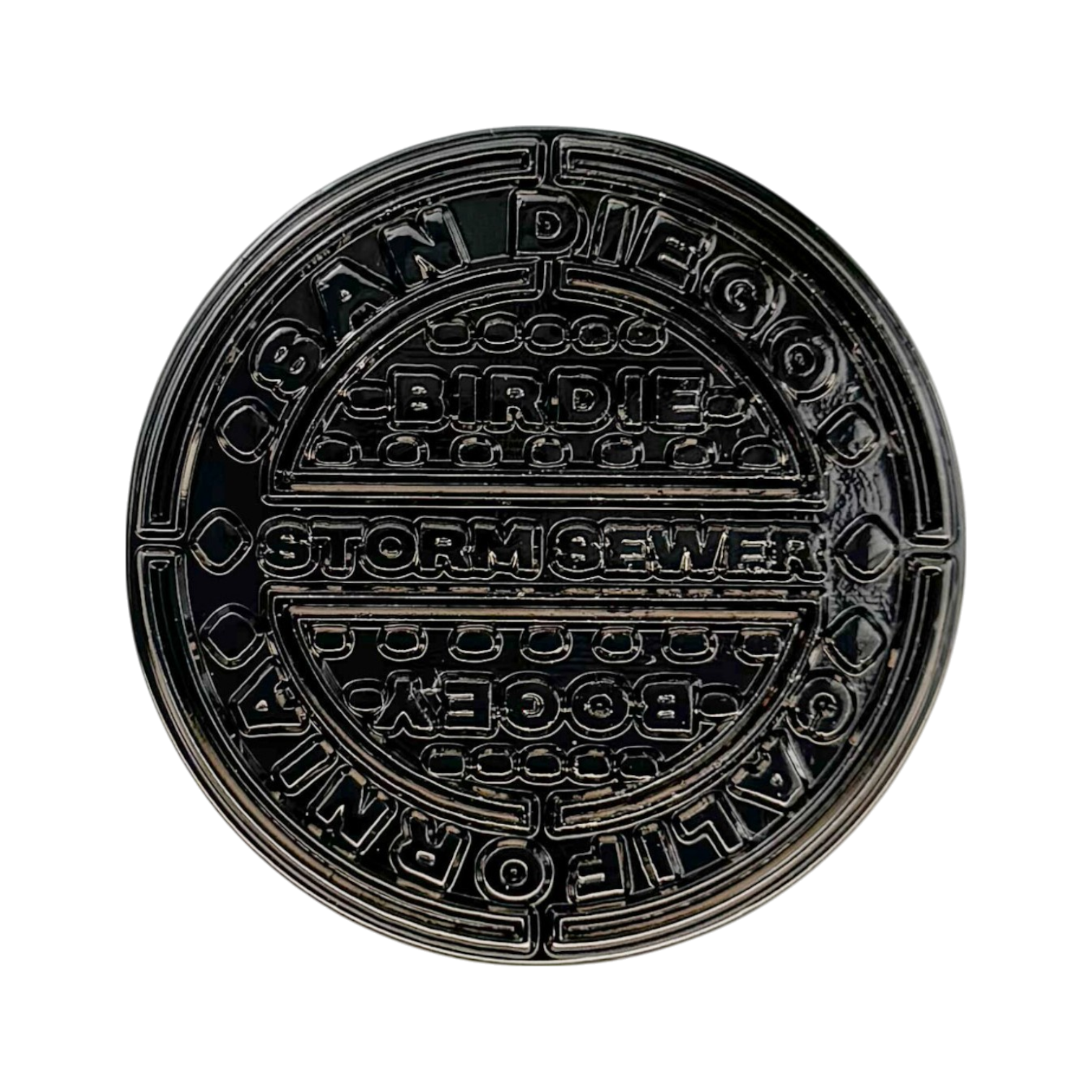 Manhole‑cover style golf ball marker with street‑wise texture and metal finish