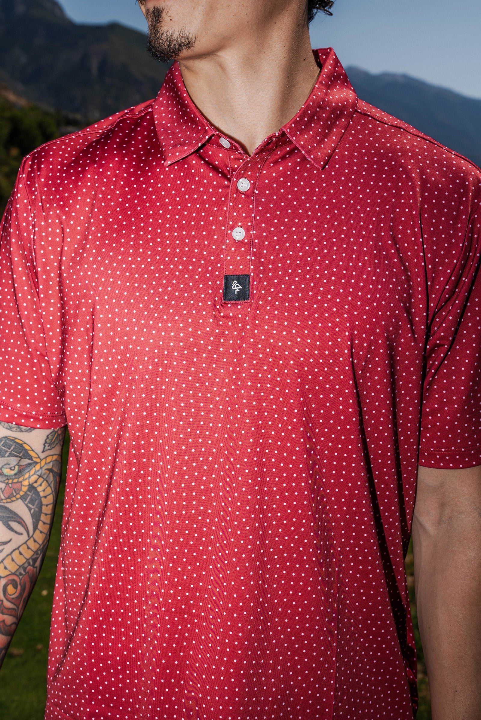 Men’s red polo with white polka dots – playful retro print with stretch, moisture-wicking, and wrinkle-resistant performance