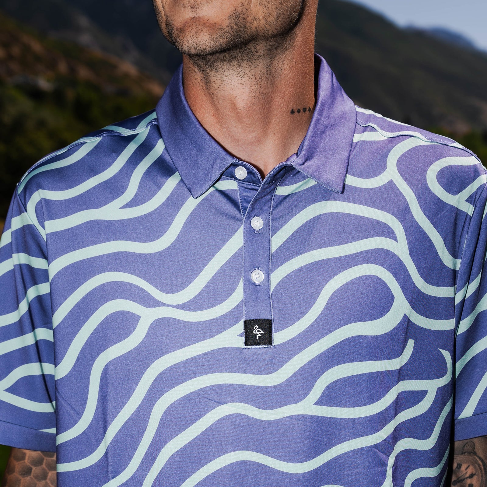 Men’s mint green and chocolate swirl pattern polo – bold, breathable, stretch-performance shirt.