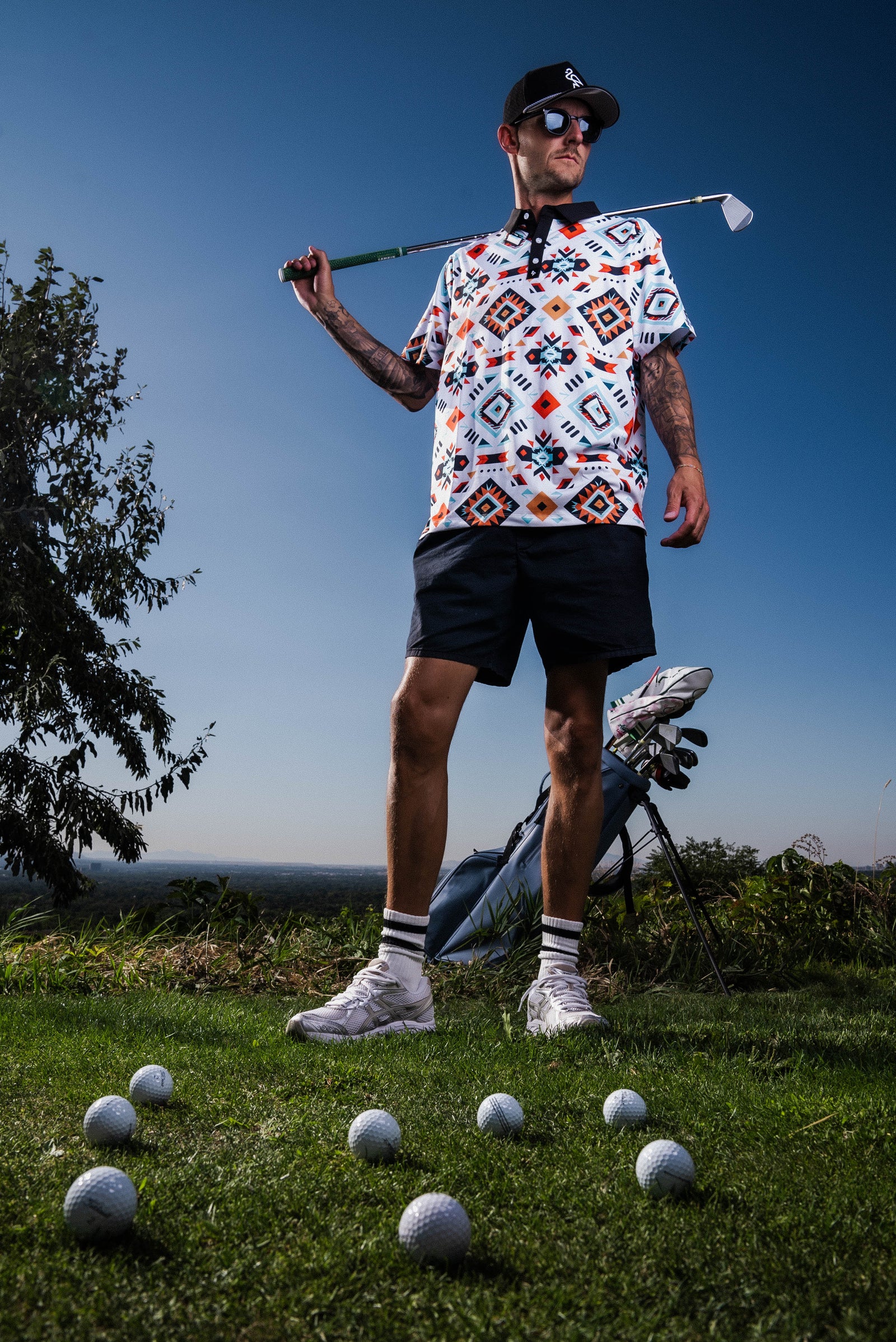 Men’s Aztec-print polo with tribal geometric motifs – vibrant, breathable, stretch-fit with performance features.