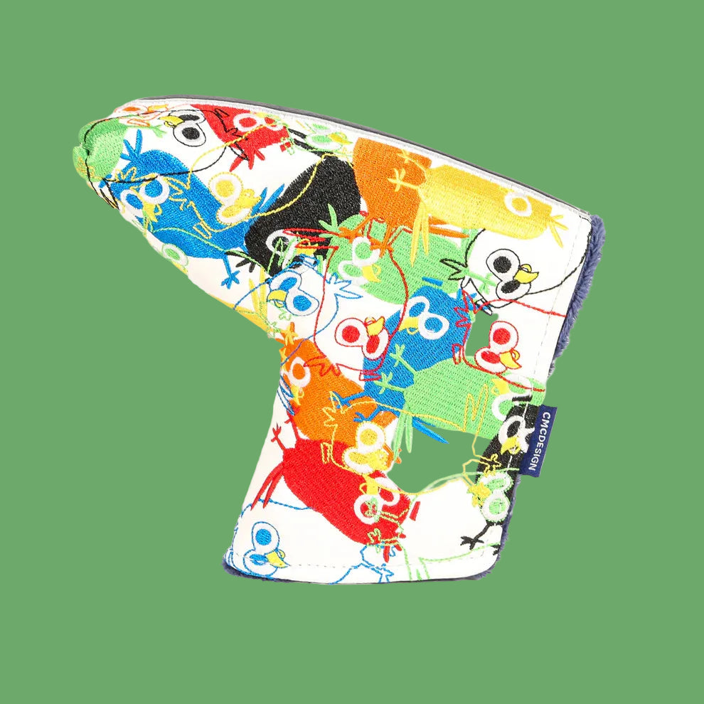 Colorful putter head cover with embroidered birds, flowers, and playful designs in blue, red, yellow, orange, and green on cream fabric with purple trim