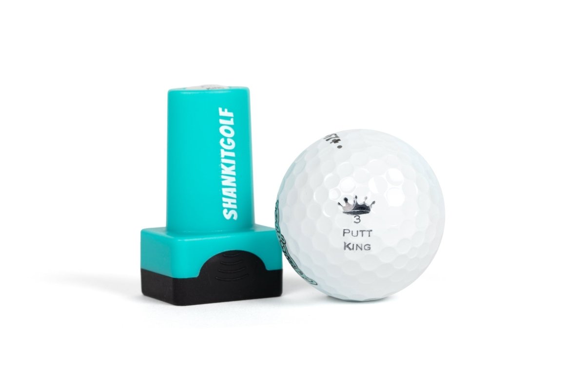 Turquoise and black ball stamper with "SHANKITGOLF" text next to white golf ball stamped with crown icon and "PUTT KING" text