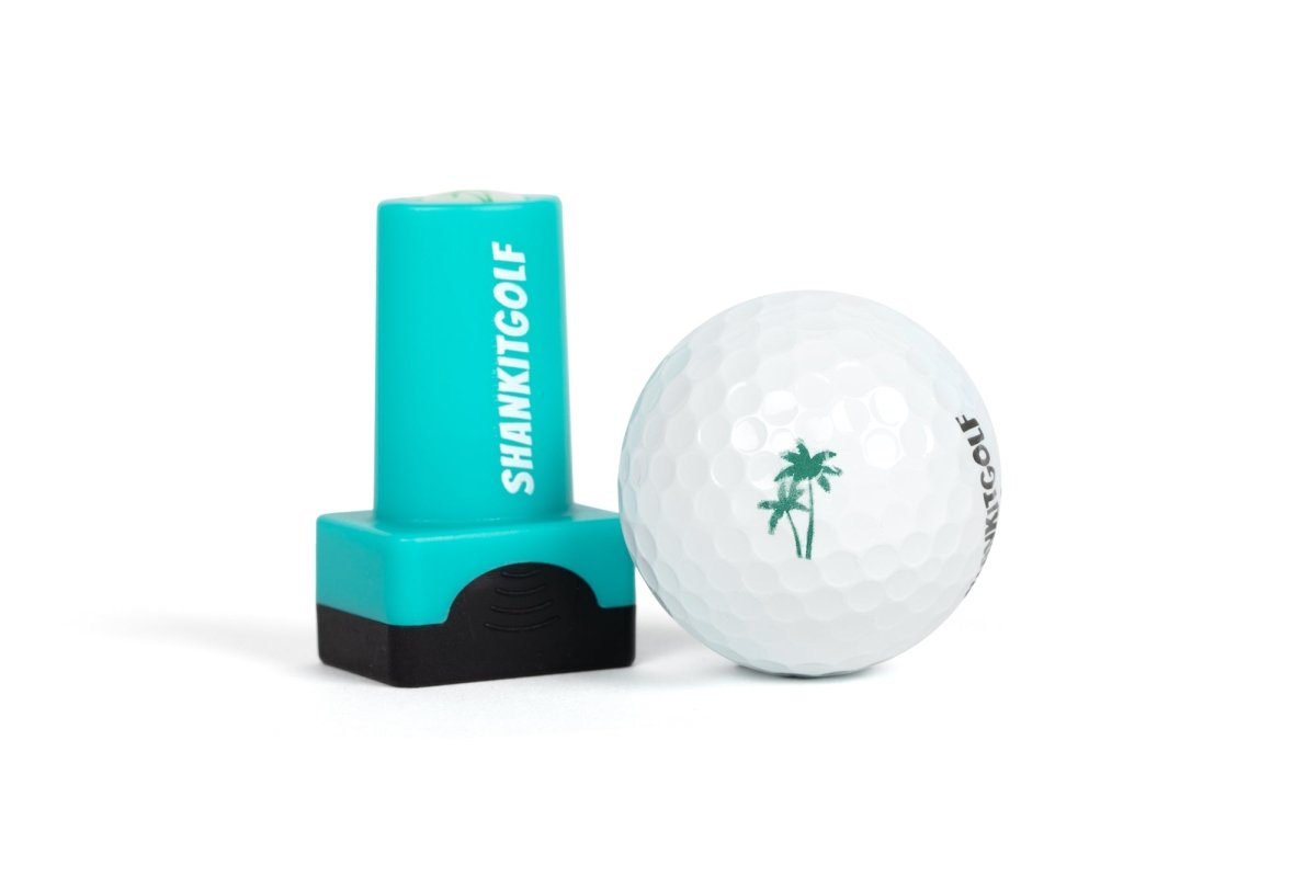 Turquoise and black ball stamper with "SHANKITGOLF" text displayed next to white golf ball stamped with sample palm tree design
