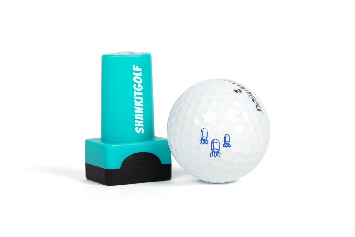 Turquoise and black ball stamper with "SHANKITGOLF" text displayed next to white golf ball stamped with sample rocket ship design in blue ink