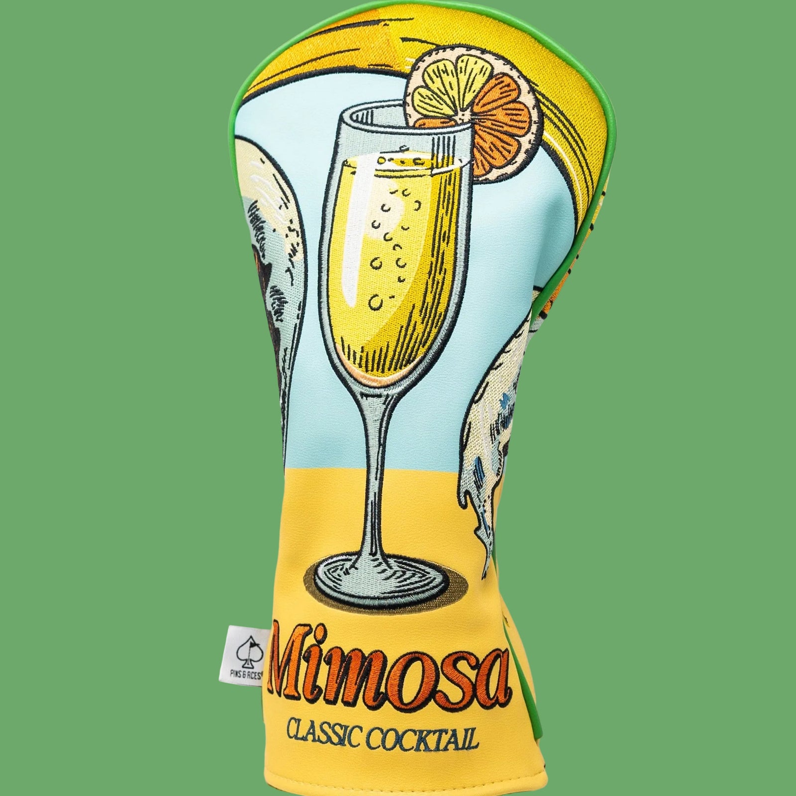 Driver headcover featuring retro illustration of a champagne flute with orange slice and yellow sun against green and blue background, labeled "Mimosa Classic Cocktail