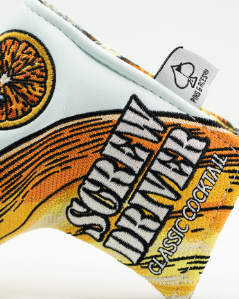 Screwdriver putter headcover with embroidered orange slice and cocktail design, showing detail of text and stitching on synthetic leather material
