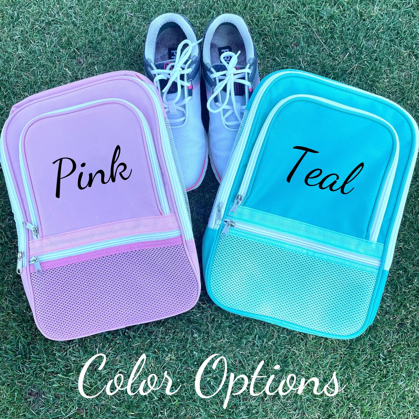 Two personalized golf shoe bags displayed on grass next to golf shoes, with sample names "Pink" and "Teal" embroidered on lavender and turquoise bags