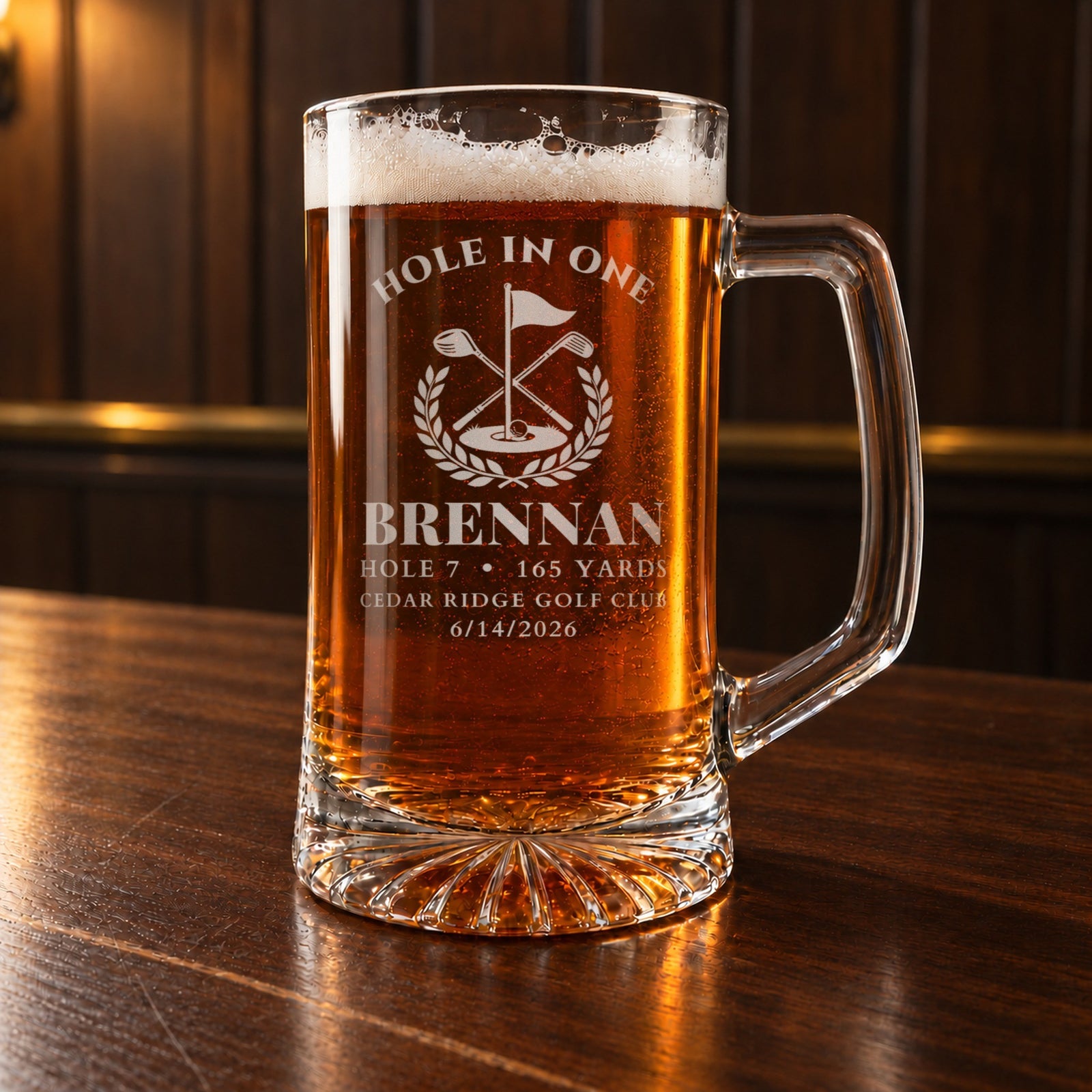 Hole in one gift: a personalized 25 oz glass beer stein engraved HOLE IN ONE over a golf flag crest, BRENNAN, hole 7, 165 yards, Cedar Ridge Golf Club, 6/14/2026