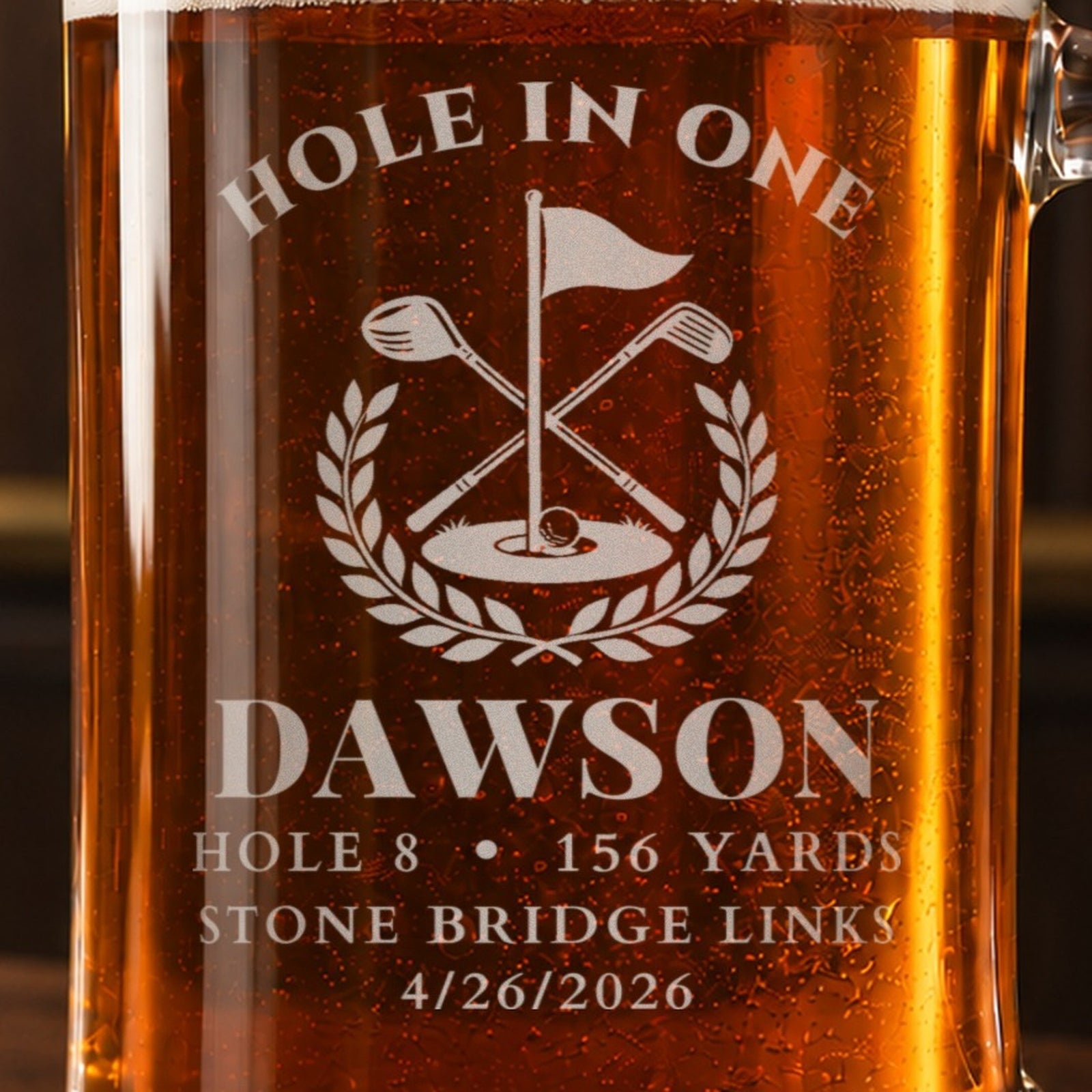 Close-up of the frosted hole in one golf flag crest engraving reading DAWSON, HOLE 8, 156 YARDS, STONE BRIDGE LINKS and 4/26/2026