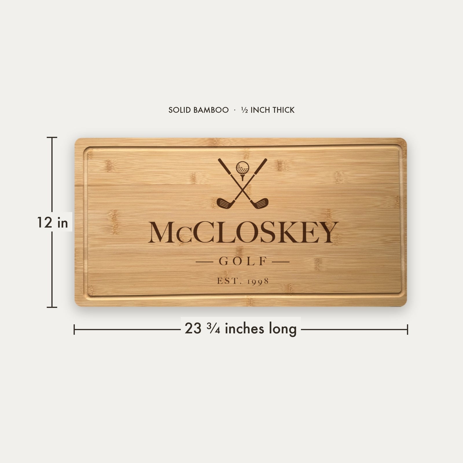 Size guide for the personalized golf cutting board, 23 and three quarter inches long by 12 inches wide in half inch thick solid bamboo.