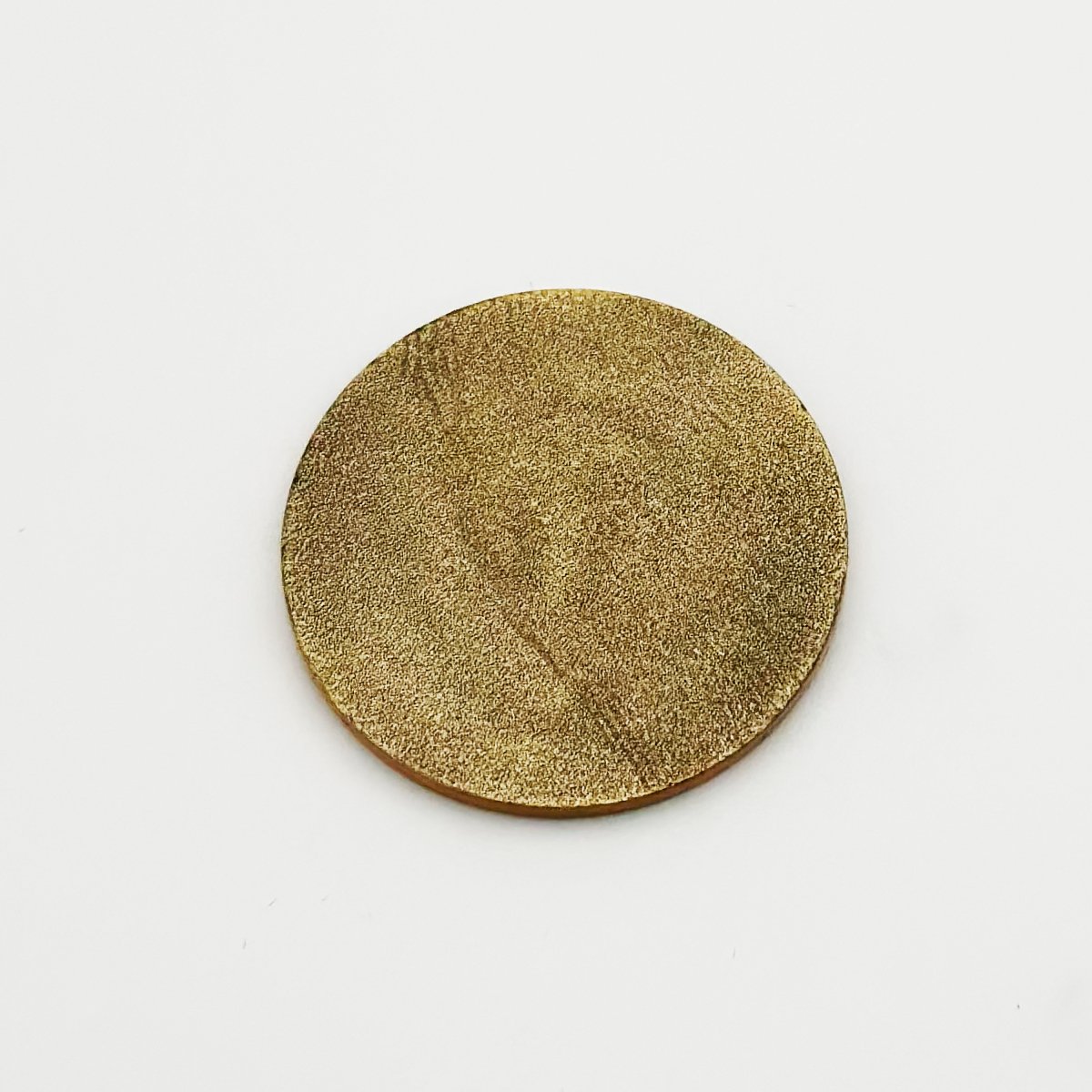 Gold glitter-finish circular golf ball marker with textured surface, shown against white background