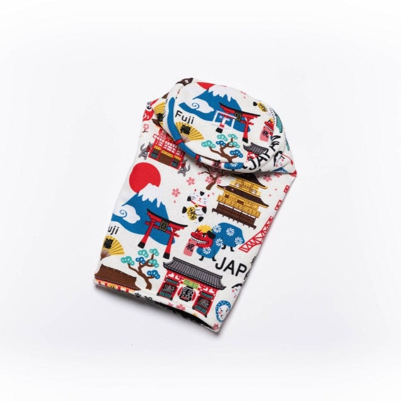Rolled Tokyo head cover displaying embroidered pattern with Mount Fuji, pagodas, and Japanese architecture in red, blue, and gold on cream fabric