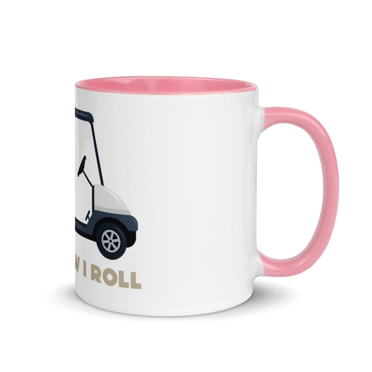 White ceramic mug with pink handle and interior, featuring golf cart illustration and "THIS IS HOW I ROLL" text in tan lettering