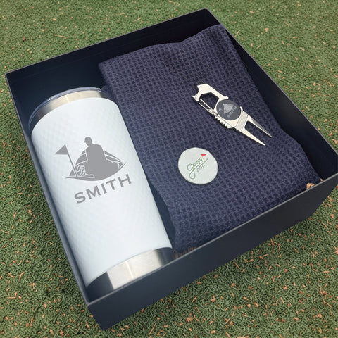 Personalized golf gift box containing an insulated tumbler, a waffle golf towel and a divot tool with a magnetic ball marker, engraved with a name
