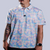 Men's off-white polo with pastel watercolor petal print – floral elegance with performance stretch and sun protection.