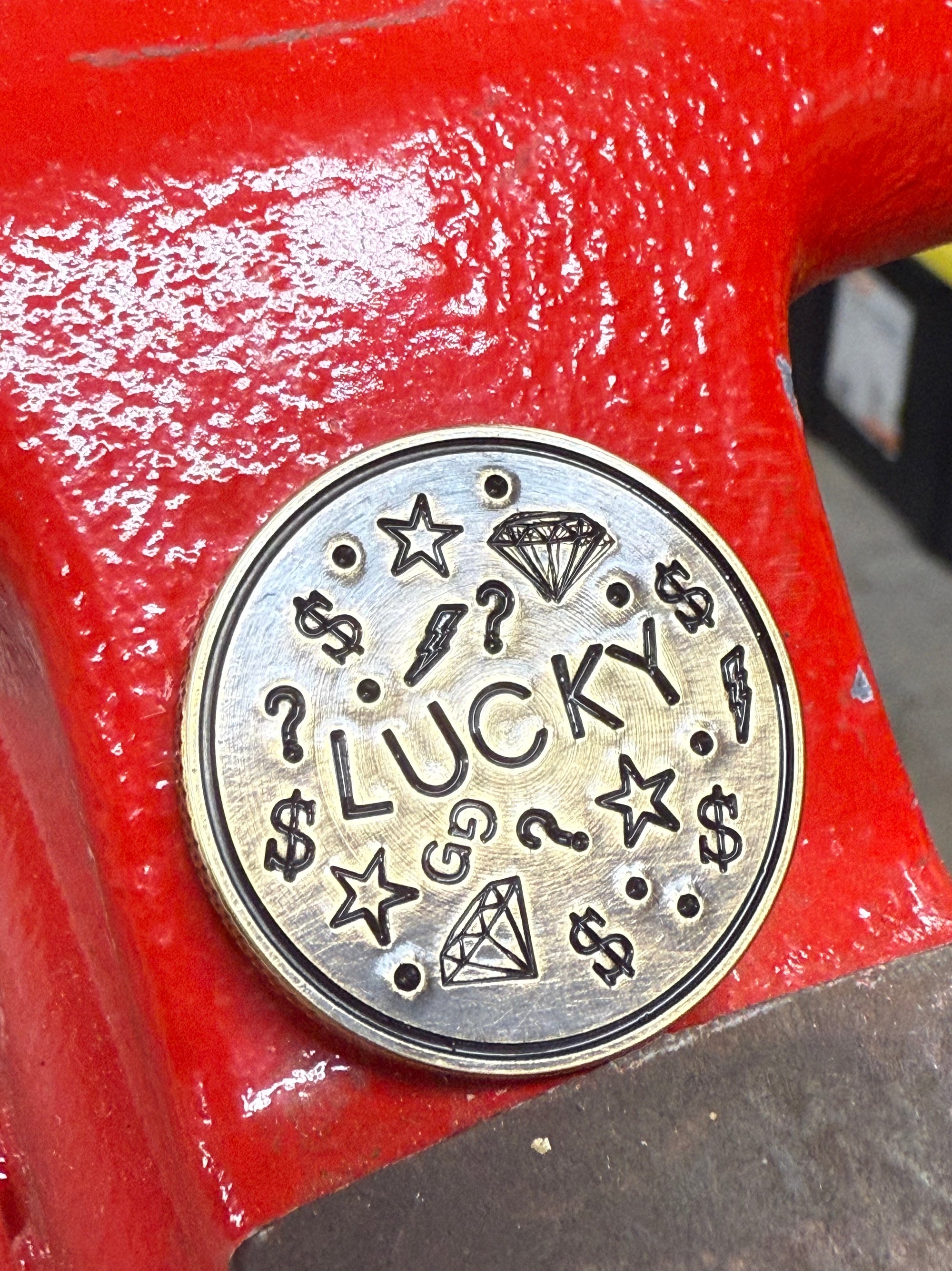 golf ball marker with "Lucky" design