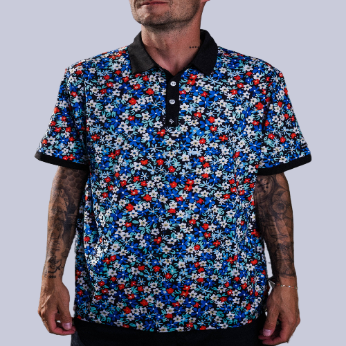 Men’s white polo with delicate pastel flower print – subtle floral detail, breathable, stretch-performance shirt.