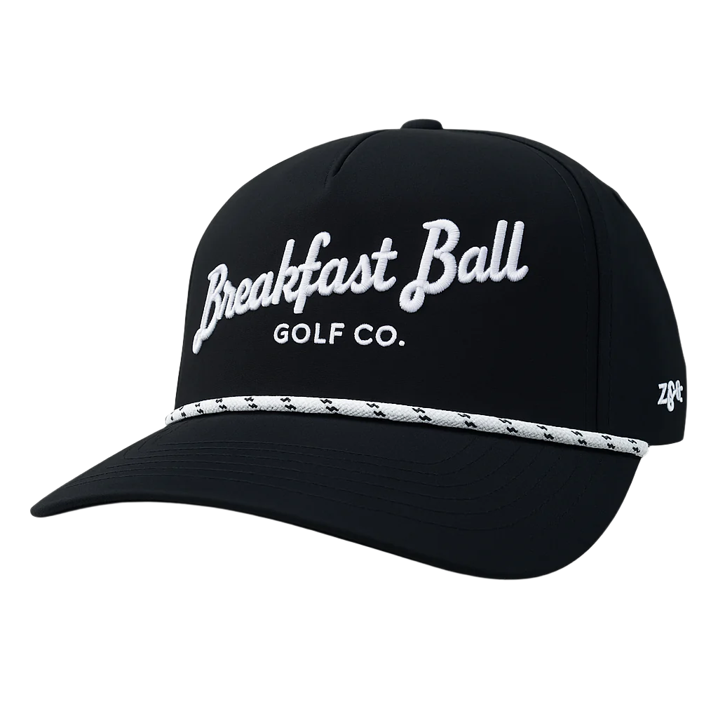 Black cap with &#39;Breakfast Ball Golf Co.&#39; text on a white background