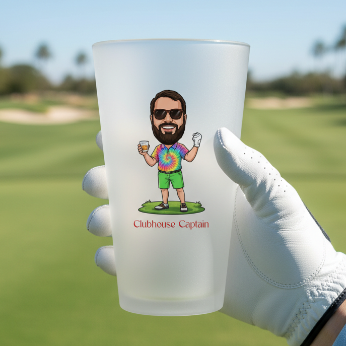 Frosted glass cup with a character design held by a gloved hand on a golf course.