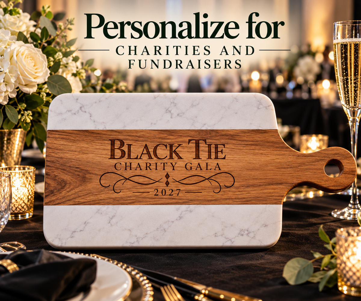 Marble and acacia wood board engraved with a Black Tie Charity Gala 2027 design on a banquet table, a custom prize idea for charity golf fundraisers.