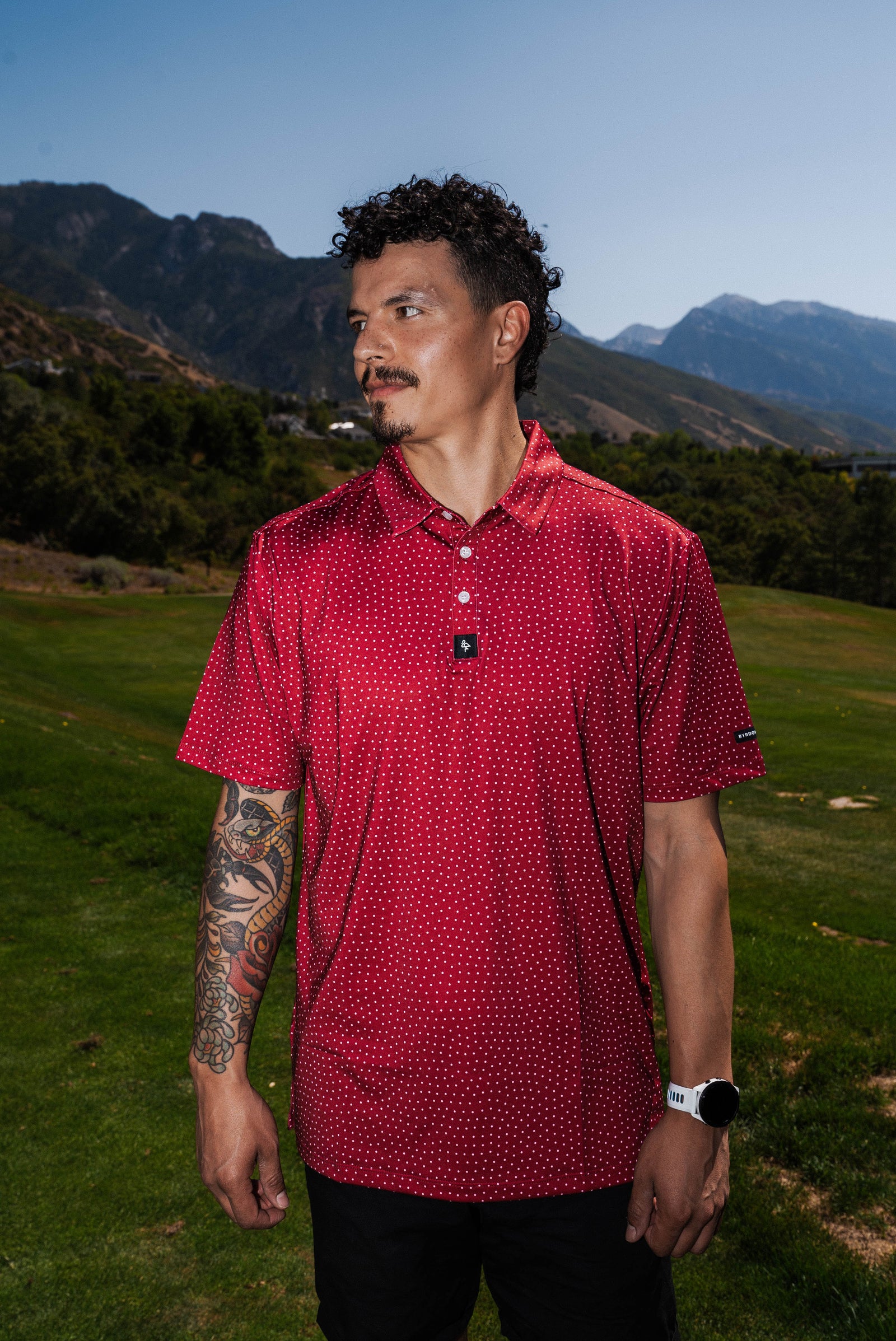 Men’s red polo with white polka dots – playful retro print with stretch, moisture-wicking, and wrinkle-resistant performance
