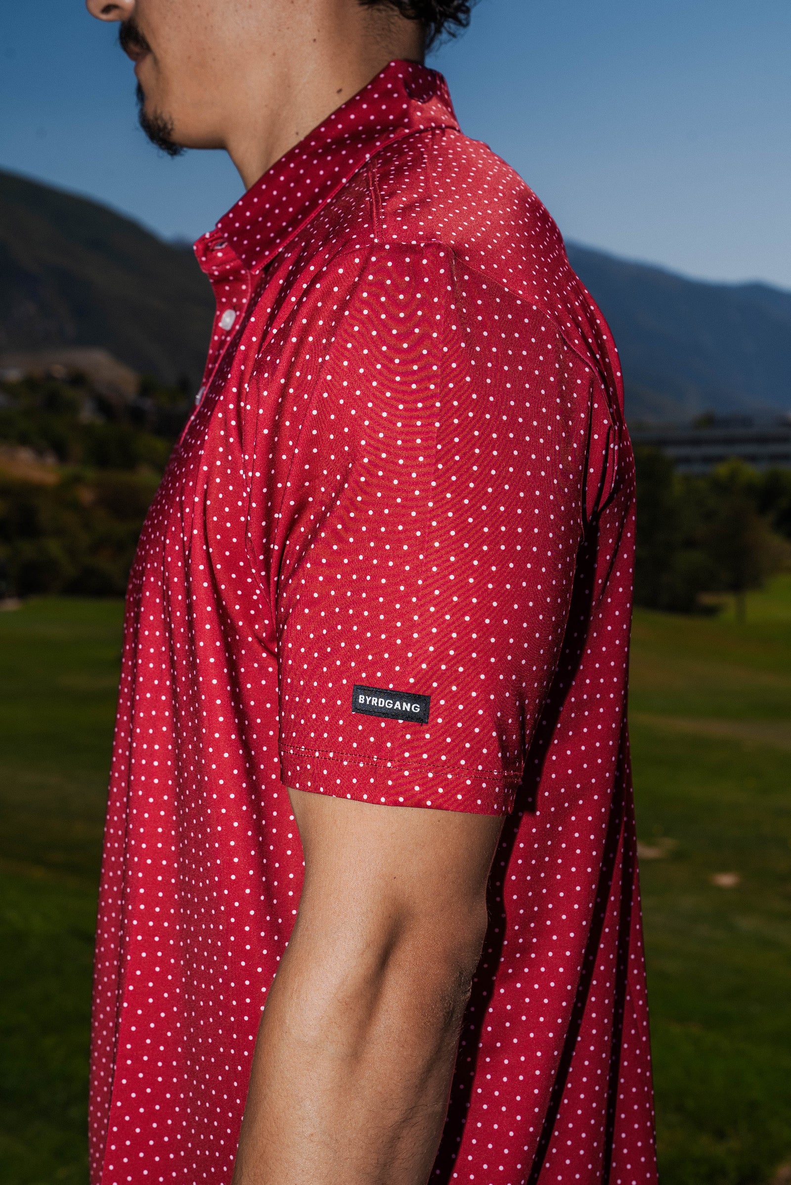Men’s red polo with white polka dots – playful retro print with stretch, moisture-wicking, and wrinkle-resistant performance