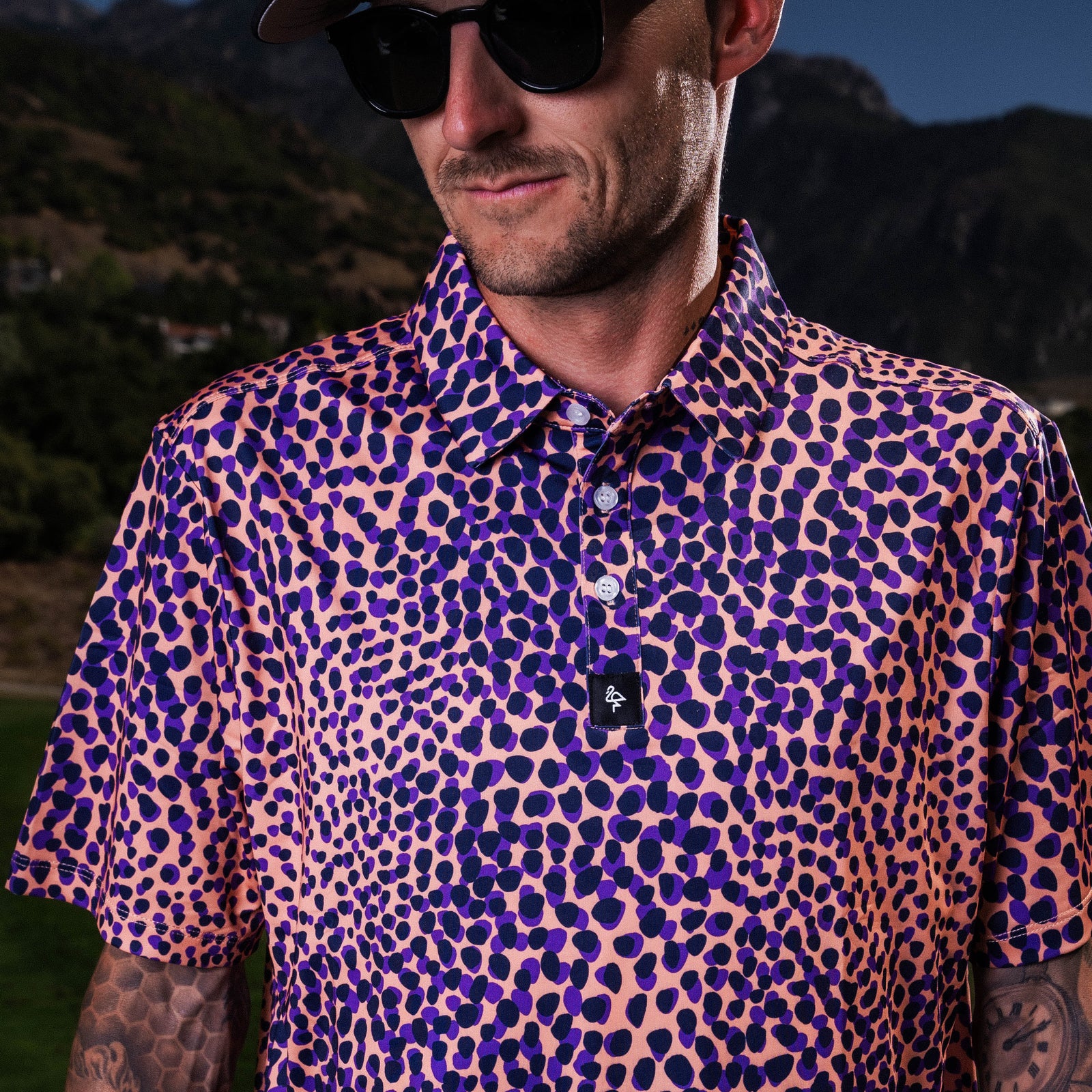 Men’s purple and tan leopard-print polo – bold animal print with stretch-performance and sun protection.