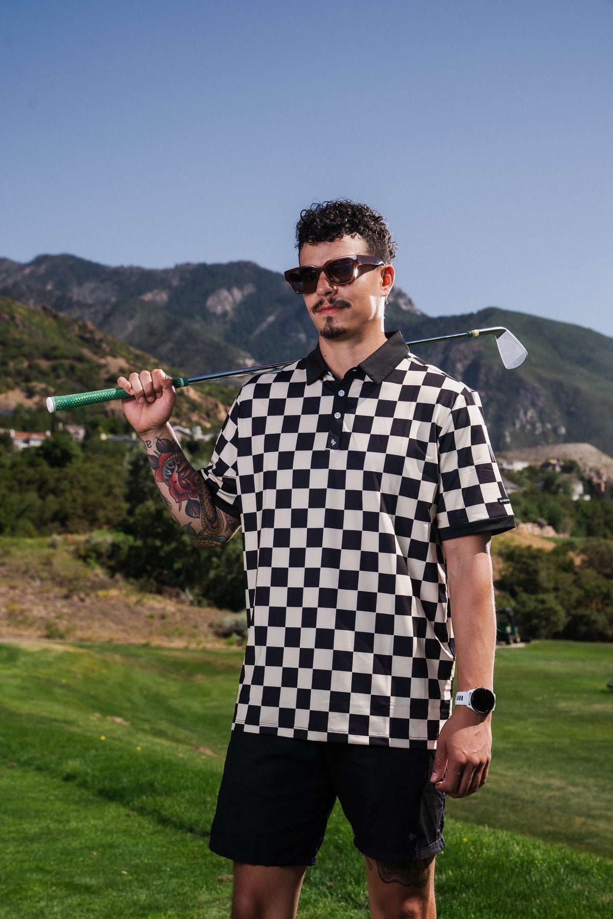 Men’s black-and-white checkerboard polo – retro-inspired, breathable, stretch-performance ready.