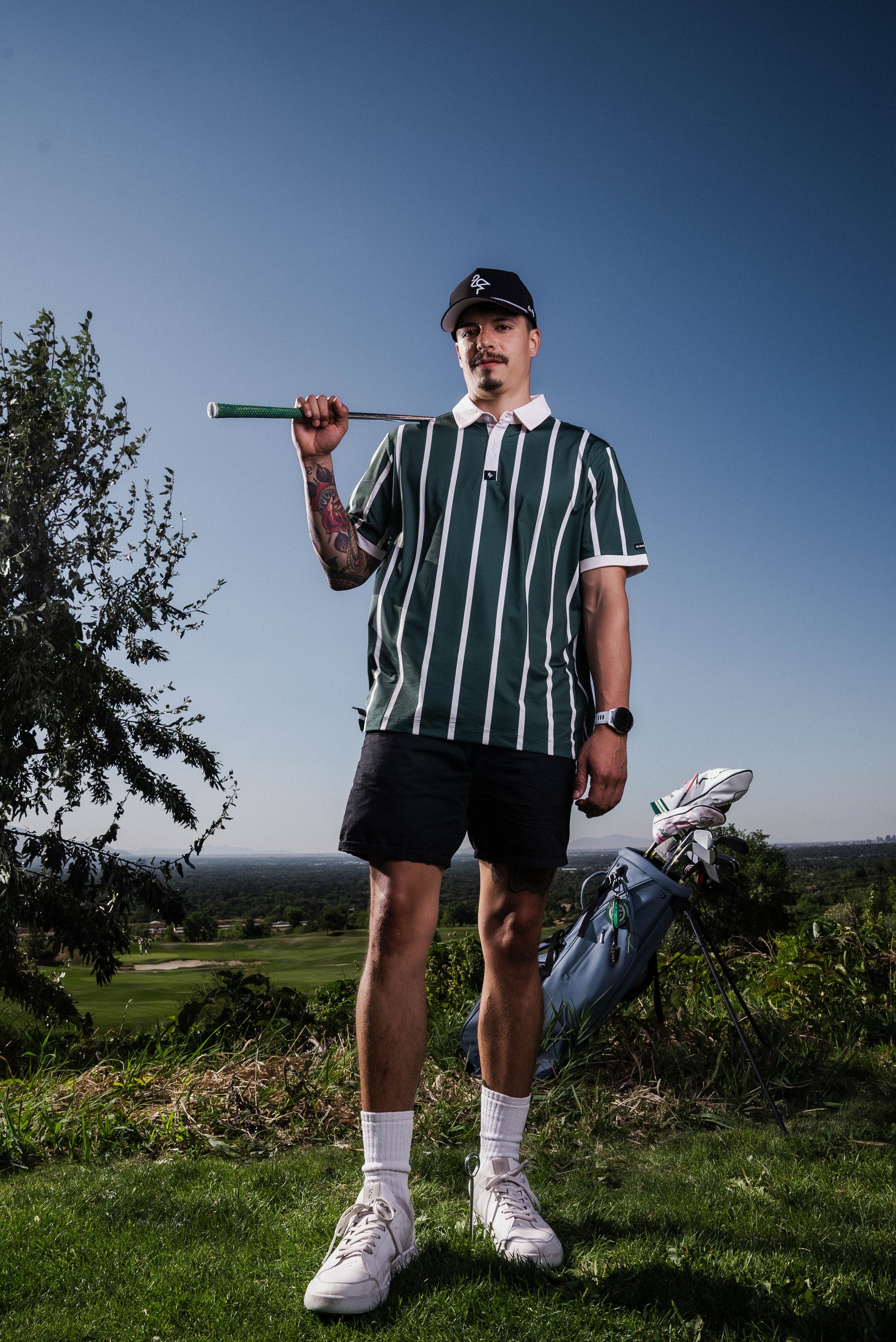 Men's green polo with retro horizontal stripes – athletic, breathable, stretch fit perfect for casual wear, golf, or travel.