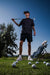 Men’s black polo with subtle gray-white speckle “cosmic sprinkle” print – sleek, breathable, stretch-performance ready.