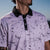 Men’s cream polo with subtle drip-splatter texture and contrast black collar—classic and breathable performance fit.
