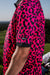 Men’s hot pink polo with black micro-spot pattern – bold, breathable, and stretch-fit performance.