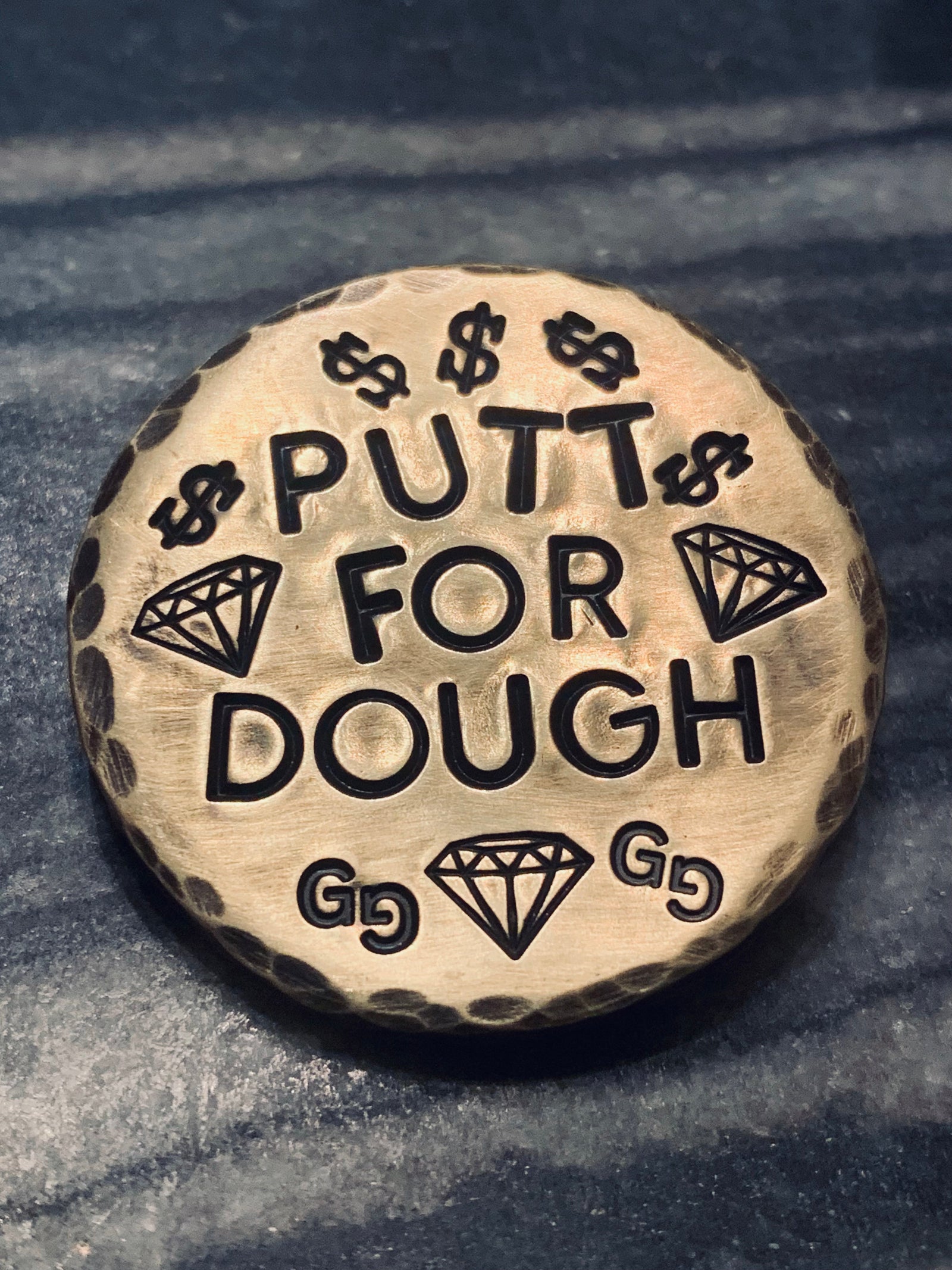 brass golf ball marker engraved with Drive for Show and Putt for Dough