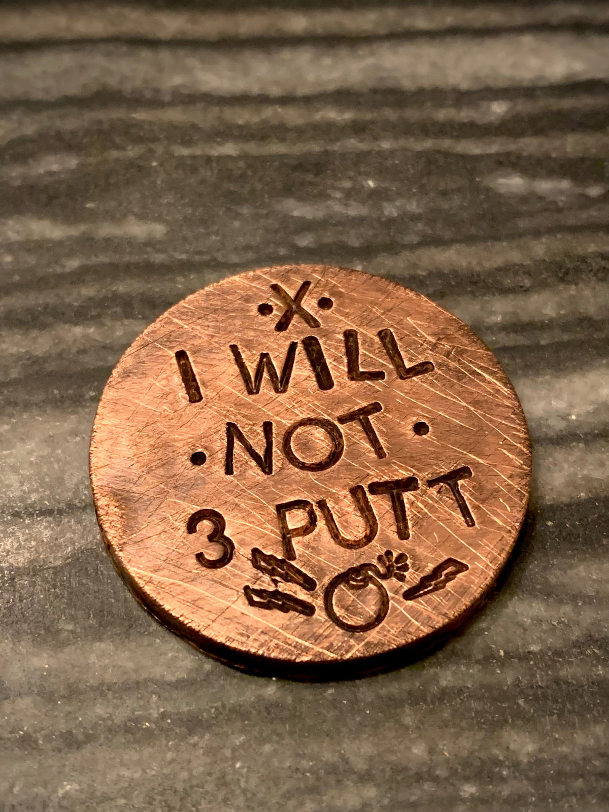 brass golf ball marker engraved “I WILL NOT 3 PUTT”