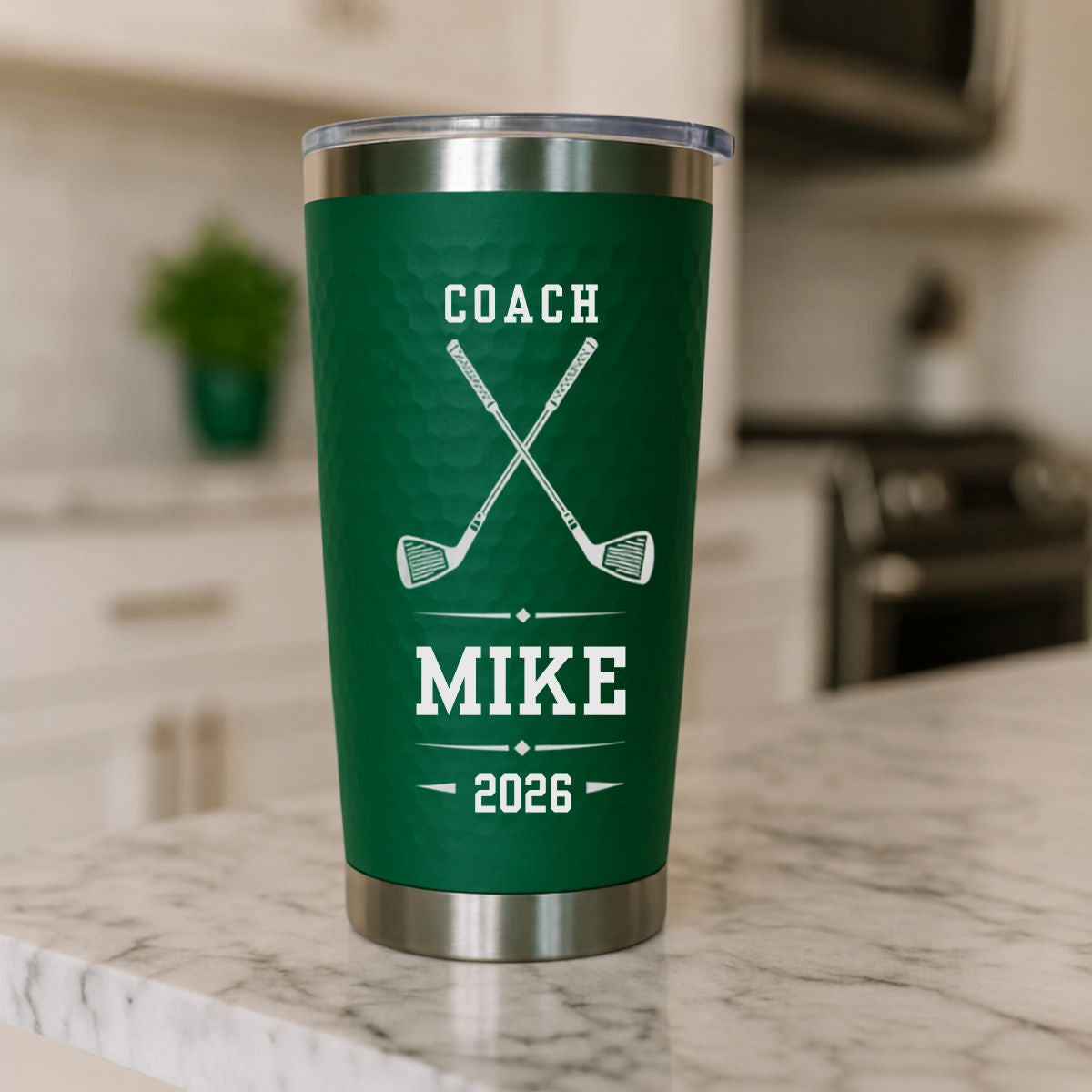Green dimpled golf coach tumbler engraved COACH with crossed clubs, MIKE and 2026, a personalized end of season gift from the golf team