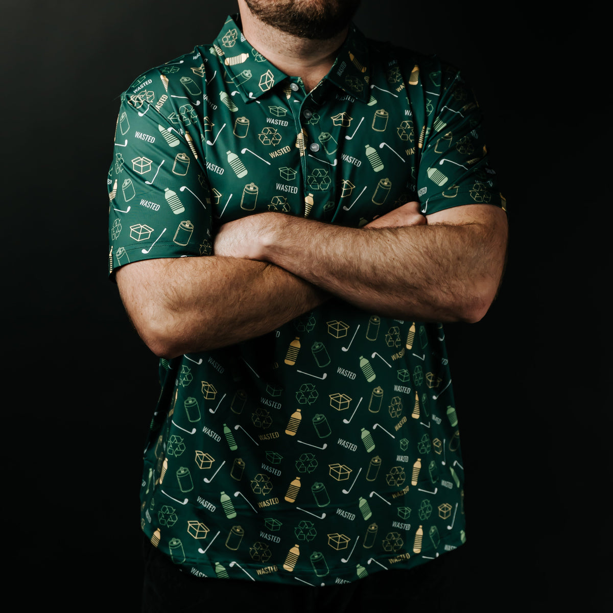 Man wearing a green patterned shirt and white cap against a black background