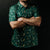 Man wearing a green patterned shirt and white cap against a black background