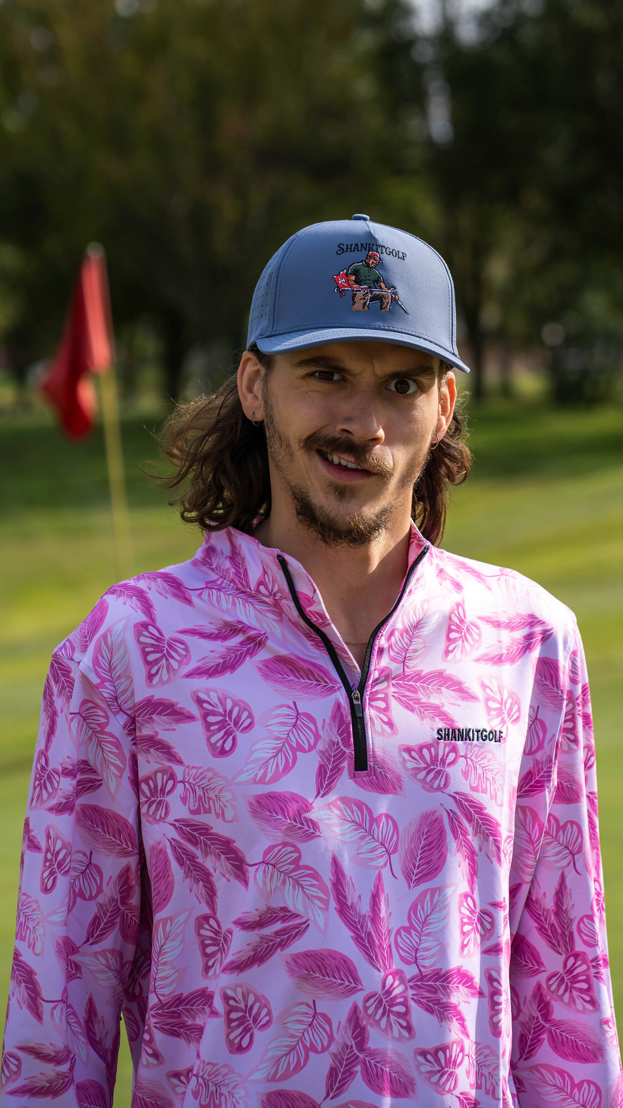 Adjustable golf hat with snap closure and breathable material.