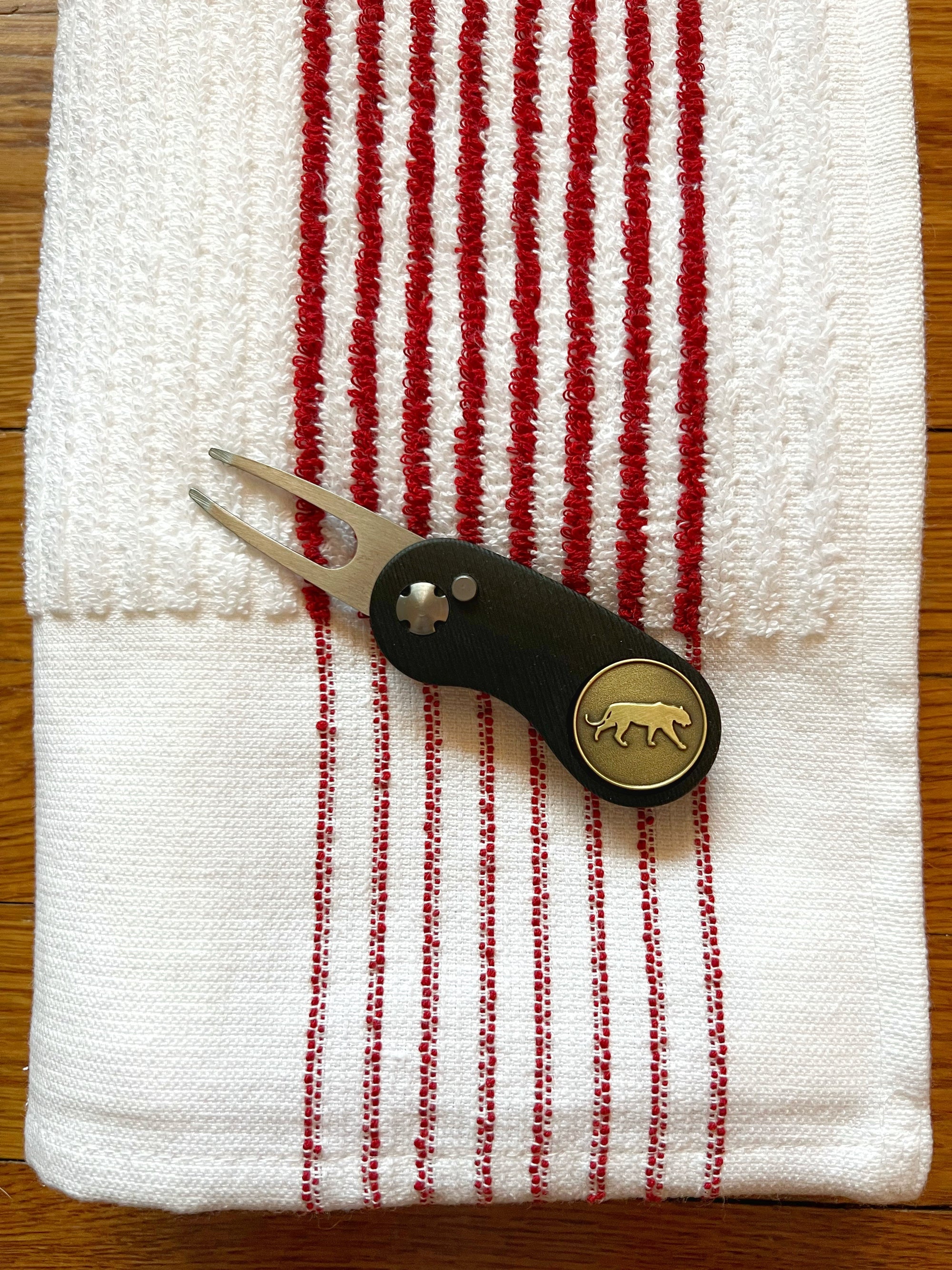 The Tiger Bundle red-striped golf towel, divot tool, magnetic ball marker