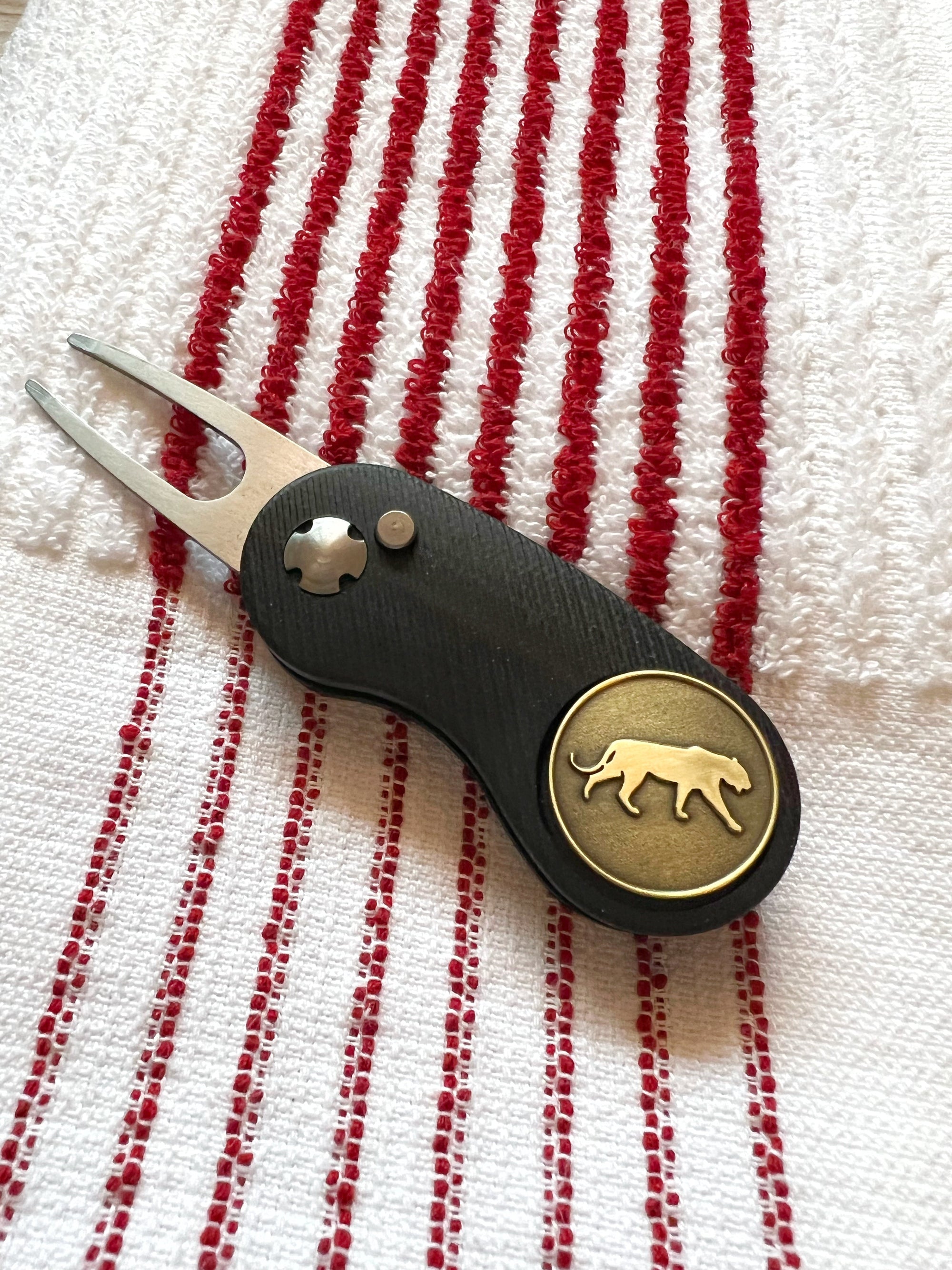 The Tiger Bundle red-striped golf towel, divot tool, magnetic ball marker