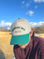 White and green cap with 'Breakfast Ball Golf Co.' text on a white background