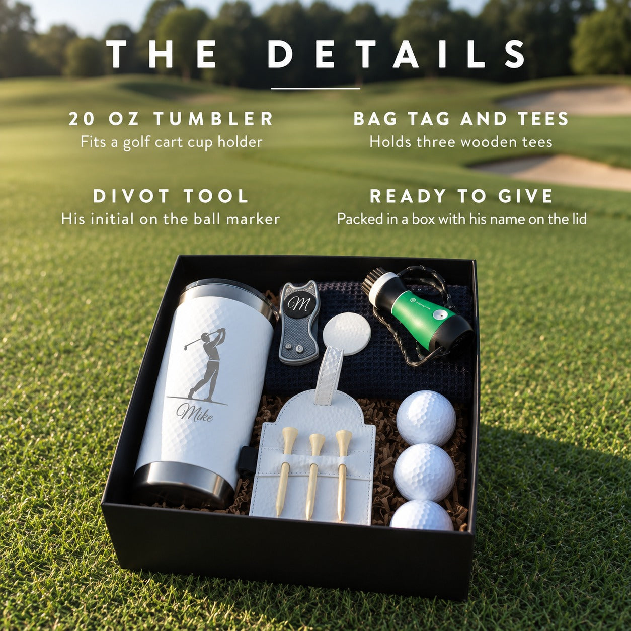 Open personalized golf gift box with an engraved 20 oz tumbler, bag tag holding three tees, divot tool, club brush, navy towel and three golf balls