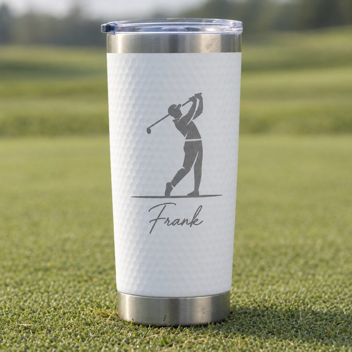 Close-up of the white golf ball textured 20 oz tumbler laser engraved with a golfer silhouette and the name Frank, a birthday gift for golf lovers